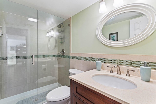6662 Boca Del Mar Dr Unit 118, Boca Raton, FL 33433 - full bath featuring a stall shower, vanity, tile walls, and wainscoting