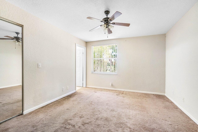 841 Summit Lake Dr, West Palm Beach, FL 33406 - unfurnished bedroom featuring carpet floors, a textured ceiling, a ceiling fan, a closet, and a textured wall