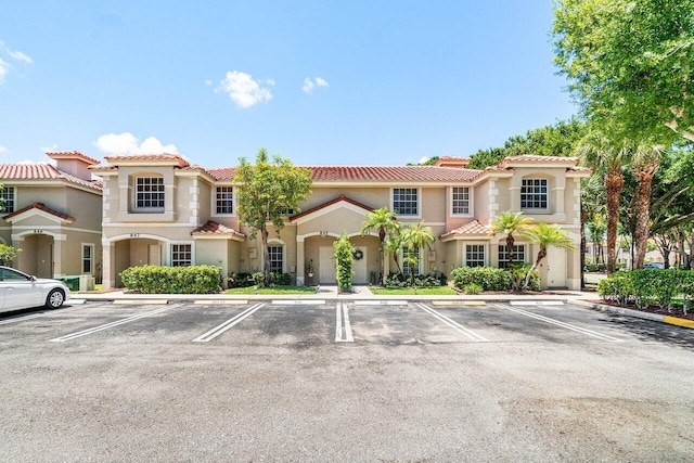 841 Summit Lake Dr, West Palm Beach, FL 33406 - view of front of house with uncovered parking, a tile roof, and stucco siding