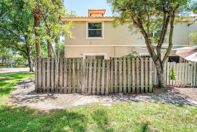 841 Summit Lake Dr, West Palm Beach, FL 33406 - rear view of house featuring stucco siding and a tiled roof