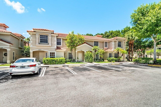 841 Summit Lake Dr, West Palm Beach, FL 33406 - view of front of house featuring uncovered parking, a tile roof, and stucco siding