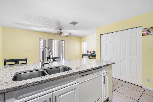 841 Summit Lake Dr, West Palm Beach, FL 33406 - kitchen featuring white dishwasher, ceiling fan, light tile patterned flooring, white cabinetry, and light stone countertops