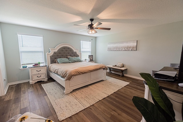 10782 SW Vasari Way, Port Saint Lucie, FL 34987 - bedroom with dark wood-style flooring, a ceiling fan, and a textured ceiling