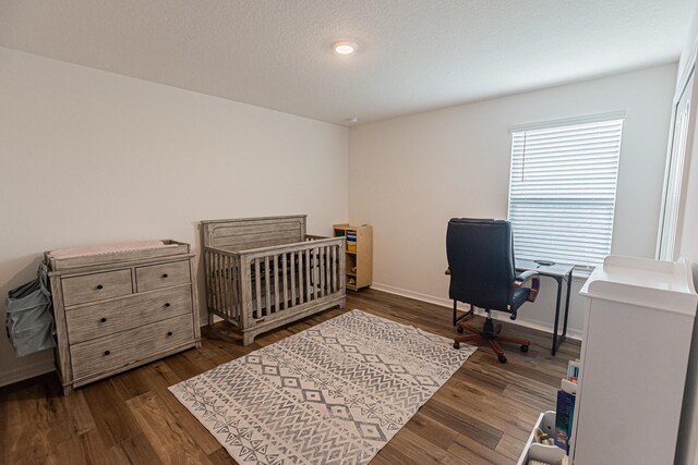 10782 SW Vasari Way, Port Saint Lucie, FL 34987 - bedroom featuring wood finished floors, a desk, and a crib