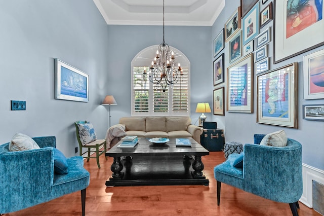 908 SW Squire Johns Ln, Palm City, FL 34990 - living room featuring a chandelier, wood finished floors, ornamental molding, and a raised ceiling