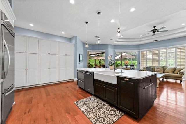 908 SW Squire Johns Ln, Palm City, FL 34990 - kitchen featuring appliances with stainless steel finishes, dark wood finished floors, light countertops, an island with sink, and recessed lighting