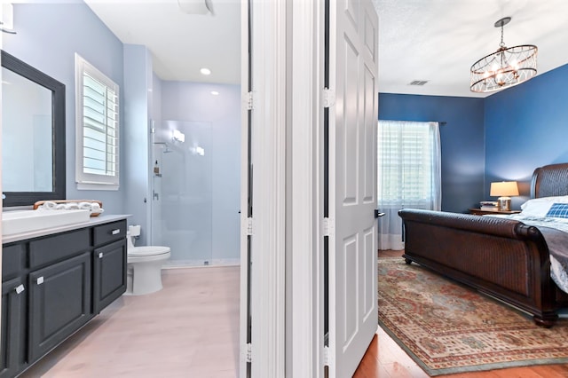908 SW Squire Johns Ln, Palm City, FL 34990 - bathroom with a shower stall, vanity, and a chandelier