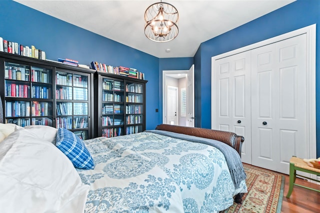 908 SW Squire Johns Ln, Palm City, FL 34990 - bedroom featuring a chandelier, a closet, and wood finished floors