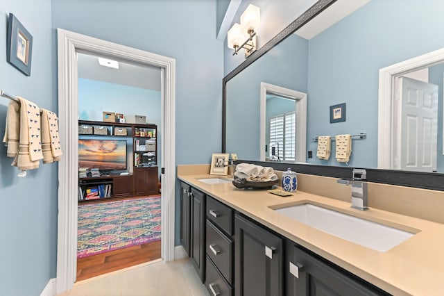 908 SW Squire Johns Ln, Palm City, FL 34990 - full bathroom featuring double vanity and baseboards