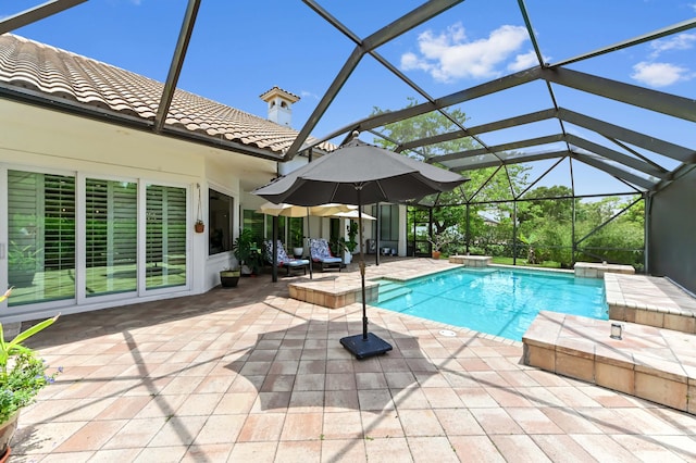 908 SW Squire Johns Ln, Palm City, FL 34990 - swimming pool featuring a patio area and glass enclosure
