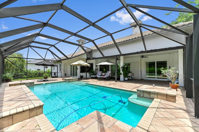 908 SW Squire Johns Ln, Palm City, FL 34990 - view of swimming pool with a patio area, a ceiling fan, a pool with connected hot tub, and a lanai
