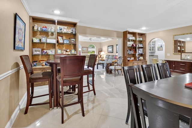 2 Fairway Dr, Boynton Beach, FL 33436 - dining space with ornamental molding, a ceiling fan, arched walkways, and light tile patterned floors