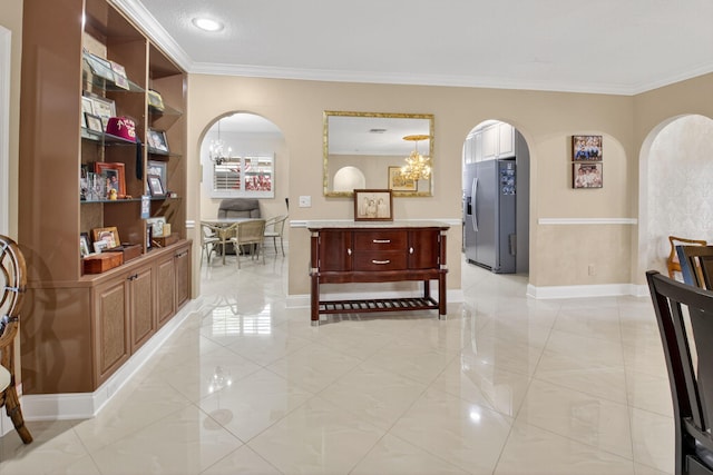 2 Fairway Dr, Boynton Beach, FL 33436 - hallway with arched walkways, ornamental molding, a chandelier, and light tile patterned floors