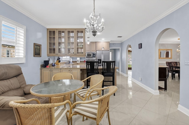 2 Fairway Dr, Boynton Beach, FL 33436 - dining area with arched walkways, a chandelier, and ornamental molding