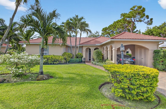 2 Fairway Dr, Boynton Beach, FL 33436 - mediterranean / spanish-style home featuring stucco siding, a front lawn, and a tile roof