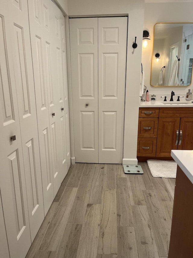 5710 Coach House F Cir Unit F, Boca Raton, FL 33486 - bathroom featuring a closet, vanity, and wood finished floors