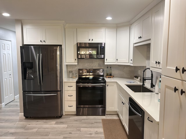 5710 Coach House F Cir Unit F, Boca Raton, FL 33486 - kitchen with stainless steel appliances, recessed lighting, light countertops, and white cabinets