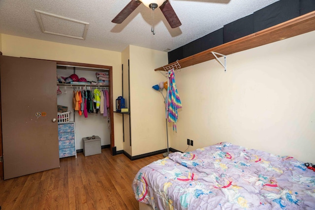 2573 SW Savona Blvd, Port Saint Lucie, FL 34953 - bedroom with wood finished floors, a closet, ceiling fan, attic access, and a textured ceiling