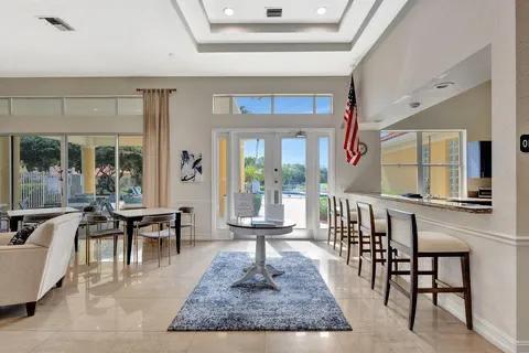 5129 Elpine Way, Riviera Beach, FL 33418 - foyer with french doors, a tray ceiling, and a high ceiling