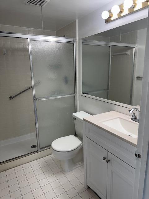 717 Sunny Pine Way Unit A2, Greenacres, FL 33415 - bathroom featuring vanity, tile patterned floors, and a shower stall