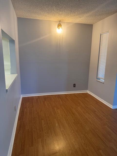 717 Sunny Pine Way Unit A2, Greenacres, FL 33415 - spare room with wood finished floors and a textured ceiling