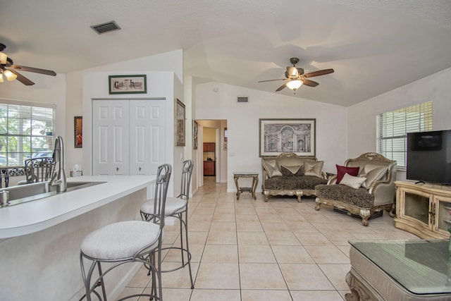 5064 El Claro Cir, West Palm Beach, FL 33415 - kitchen with ceiling fan, lofted ceiling, light tile patterned flooring, open floor plan, and light countertops
