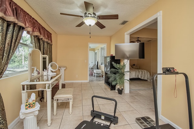 5064 El Claro Cir, West Palm Beach, FL 33415 - workout room featuring ceiling fan, a textured ceiling, and light tile patterned floors