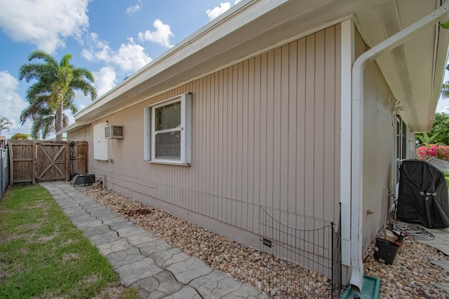 5064 El Claro Cir, West Palm Beach, FL 33415 - view of side of property featuring crawl space, a gate, and a wall mounted air conditioner