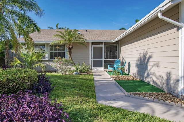 5064 El Claro Cir, West Palm Beach, FL 33415 - entrance to property with a lawn and a shingled roof