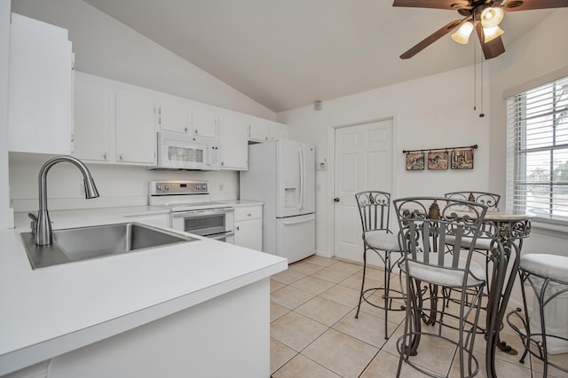 5064 El Claro Cir, West Palm Beach, FL 33415 - kitchen with white appliances, ceiling fan, light countertops, vaulted ceiling, and light tile patterned floors
