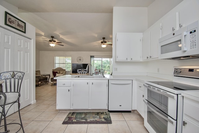 5064 El Claro Cir, West Palm Beach, FL 33415 - kitchen with white appliances, a peninsula, a ceiling fan, light tile patterned flooring, and open floor plan
