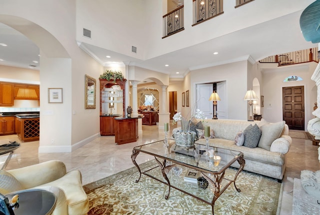 6404 Dorsay Ct, Delray Beach, FL 33484 - living area with decorative columns, light marble finish flooring, ornamental molding, arched walkways, and a towering ceiling