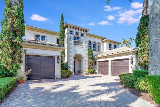 6404 Dorsay Ct, Delray Beach, FL 33484 - mediterranean / spanish-style house featuring decorative driveway, an attached garage, stucco siding, stone siding, and a tiled roof