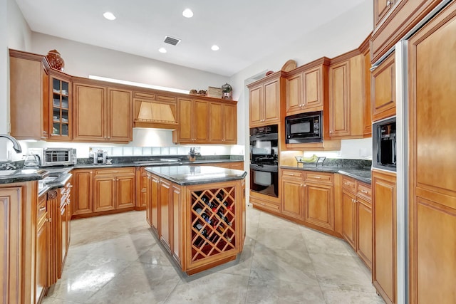 6404 Dorsay Ct, Delray Beach, FL 33484 - kitchen featuring black appliances, custom range hood, glass insert cabinets, a kitchen island, and brown cabinets
