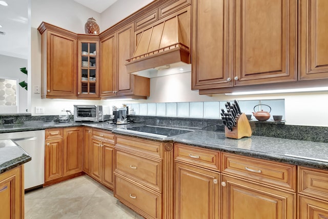 6404 Dorsay Ct, Delray Beach, FL 33484 - kitchen featuring custom range hood, stainless steel dishwasher, black electric stovetop, brown cabinets, and dark stone countertops