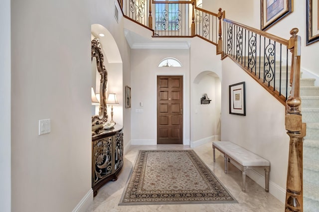 6404 Dorsay Ct, Delray Beach, FL 33484 - foyer entrance featuring arched walkways, a towering ceiling, and stairs