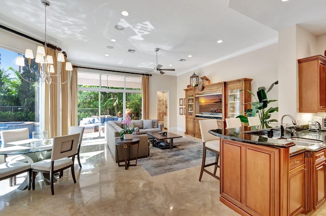 6404 Dorsay Ct, Delray Beach, FL 33484 - kitchen featuring ornamental molding, ceiling fan, dark stone counters, a breakfast bar, and open floor plan