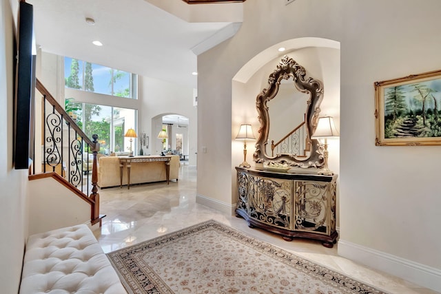 6404 Dorsay Ct, Delray Beach, FL 33484 - entryway with arched walkways, marble tiled floors, a high ceiling, recessed lighting, and stairs