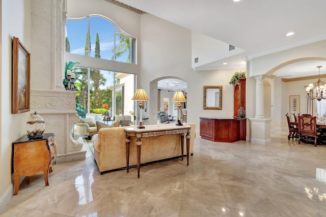 6404 Dorsay Ct, Delray Beach, FL 33484 - living room with crown molding, arched walkways, ornate columns, light marble finish floors, and a chandelier