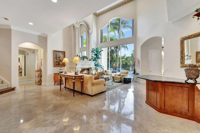 6404 Dorsay Ct, Delray Beach, FL 33484 - living area with light marble finish flooring, arched walkways, a high ceiling, ornamental molding, and stairs