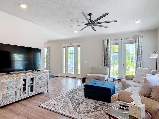 3121 Portofino Blvd, New Smyrna Beach, FL 32168 - living area with wood finished floors, ceiling fan, a textured ceiling, recessed lighting, and french doors