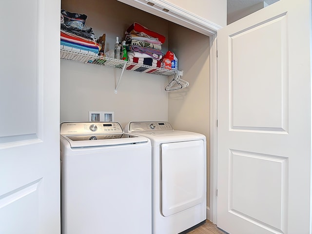 3121 Portofino Blvd, New Smyrna Beach, FL 32168 - laundry room featuring washer and clothes dryer and light wood-style flooring