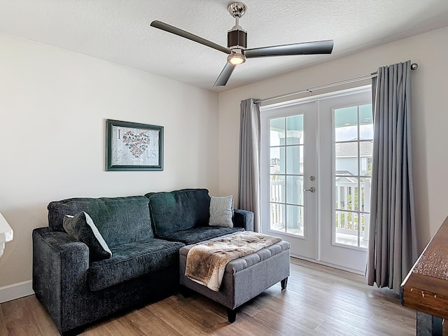 3121 Portofino Blvd, New Smyrna Beach, FL 32168 - living area featuring french doors, light wood-style floors, ceiling fan, and a textured ceiling