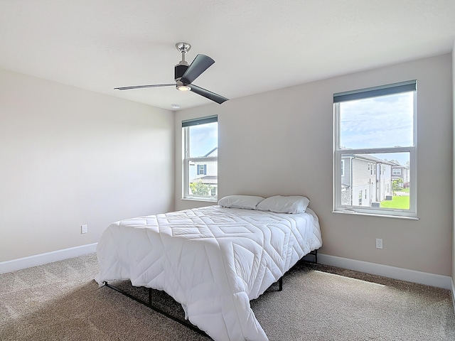 3121 Portofino Blvd, New Smyrna Beach, FL 32168 - carpeted bedroom featuring baseboards and ceiling fan