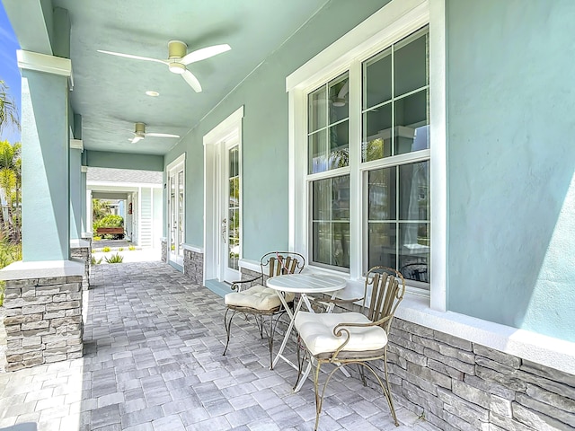 3121 Portofino Blvd, New Smyrna Beach, FL 32168 - covered porch featuring ceiling fan