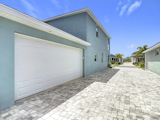 3121 Portofino Blvd, New Smyrna Beach, FL 32168 - view of home's exterior with decorative driveway and stucco siding