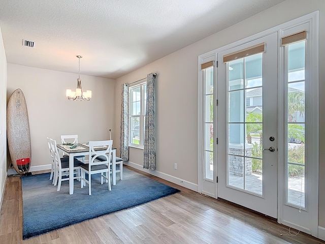 3121 Portofino Blvd, New Smyrna Beach, FL 32168 - dining room with a chandelier and wood finished floors