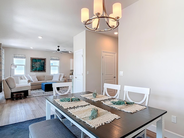 3121 Portofino Blvd, New Smyrna Beach, FL 32168 - dining area with a chandelier, wood finished floors, a ceiling fan, and recessed lighting