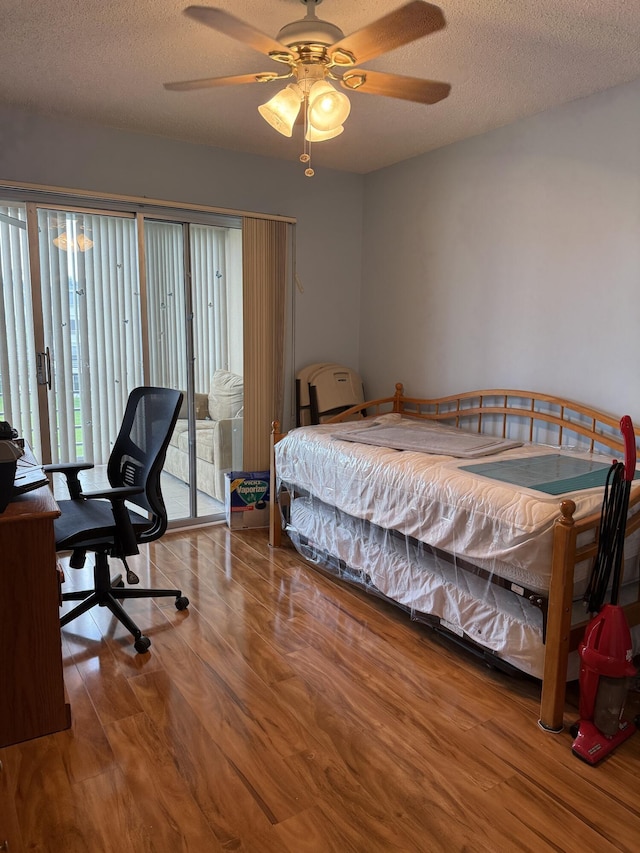 3007 Yarmouth Unit A, Boca Raton, FL 33434 - bedroom with wood finished floors, access to outside, a textured ceiling, and a ceiling fan