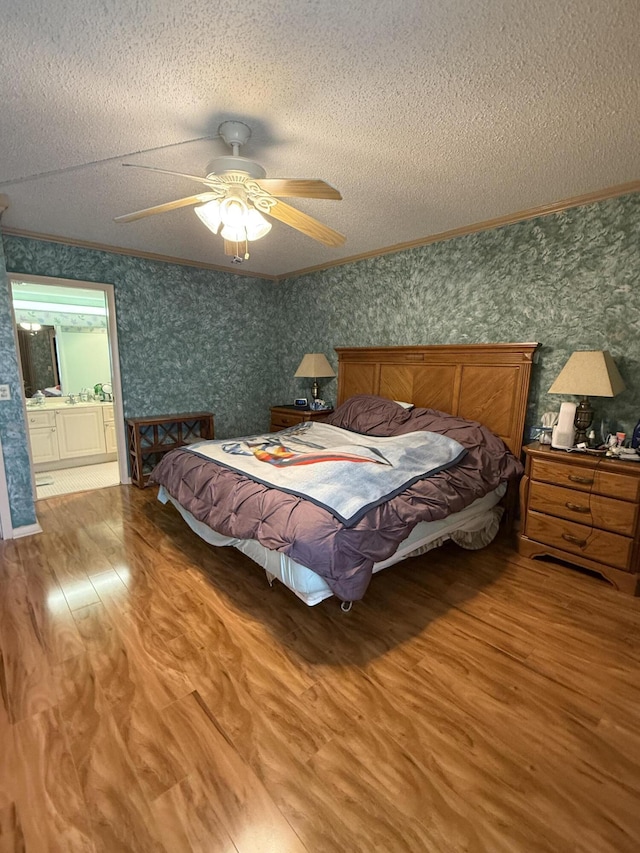 3007 Yarmouth Unit A, Boca Raton, FL 33434 - bedroom with wood finished floors, wallpapered walls, ornamental molding, a textured ceiling, and a ceiling fan